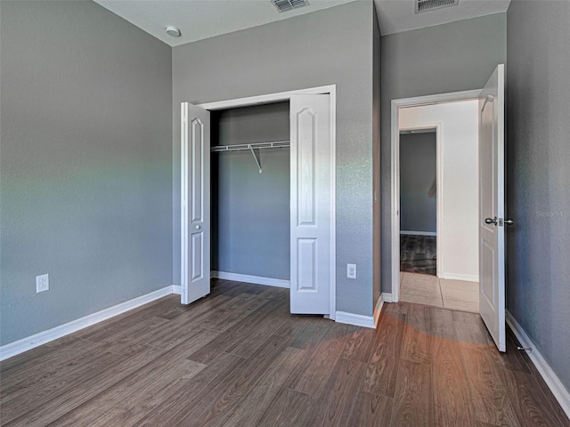 9157 Genesee St, Port Charlotte, FL 33981 - unfurnished bedroom featuring dark wood finished floors and a closet