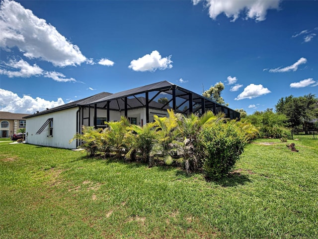 9157 Genesee St, Port Charlotte, FL 33981 - rear view of house featuring a lawn, stucco siding, and a lanai