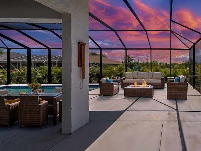 9157 Genesee St, Port Charlotte, FL 33981 - patio terrace at dusk featuring an outdoor living space with a fire pit, a patio area, an outdoor pool, and a lanai