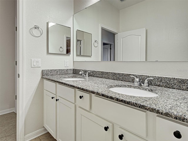 9157 Genesee St, Port Charlotte, FL 33981 - bathroom with double vanity and tile patterned flooring
