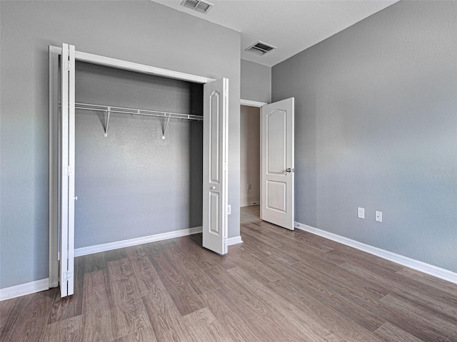 9157 Genesee St, Port Charlotte, FL 33981 - unfurnished bedroom with wood finished floors and a closet