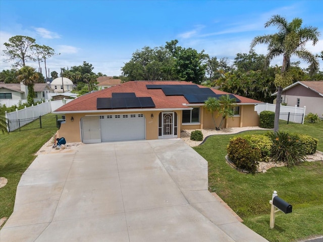 2941 Datura Rd, Venice, FL 34293 - view of front of house featuring a garage, driveway, solar panels, and stucco siding
