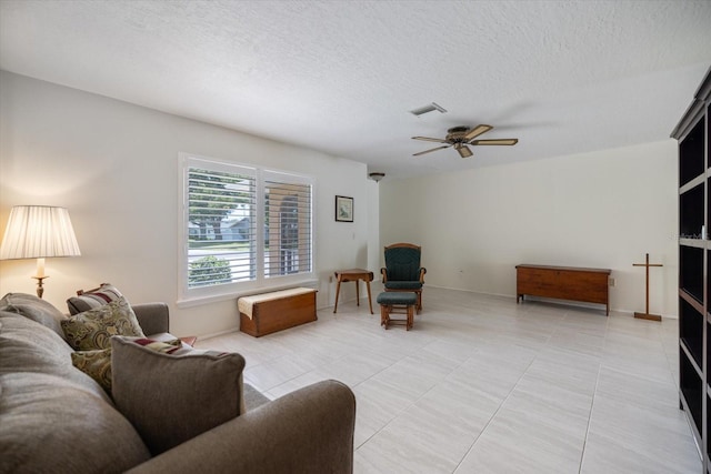 2941 Datura Rd, Venice, FL 34293 - living area featuring a ceiling fan, light tile patterned flooring, and a textured ceiling