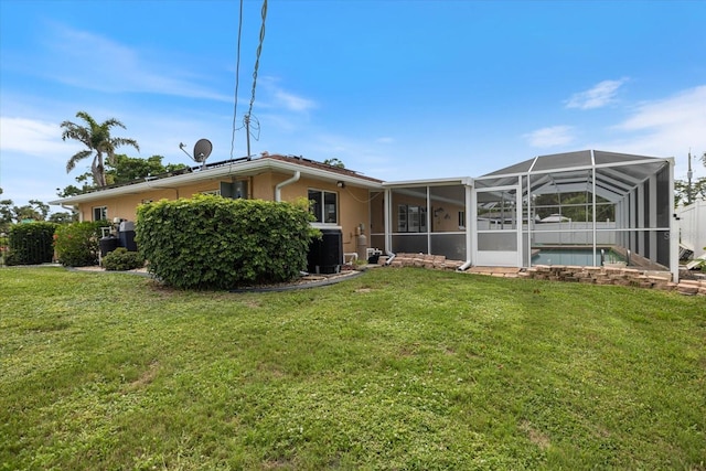 2941 Datura Rd, Venice, FL 34293 - back of property featuring a yard, an outdoor pool, and glass enclosure