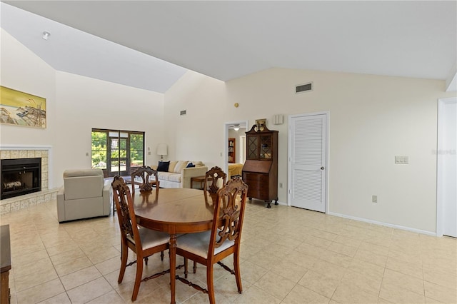 1315 Pine Needle Rd, Venice, FL 34285 - dining area with a tile fireplace, high vaulted ceiling, and light tile patterned floors