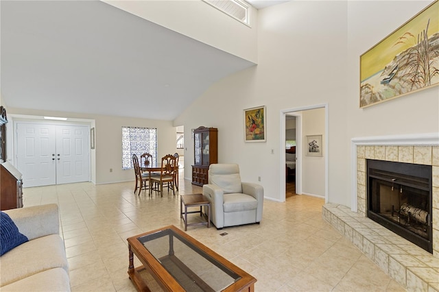 1315 Pine Needle Rd, Venice, FL 34285 - living room with a towering ceiling, light tile patterned floors, and a tiled fireplace
