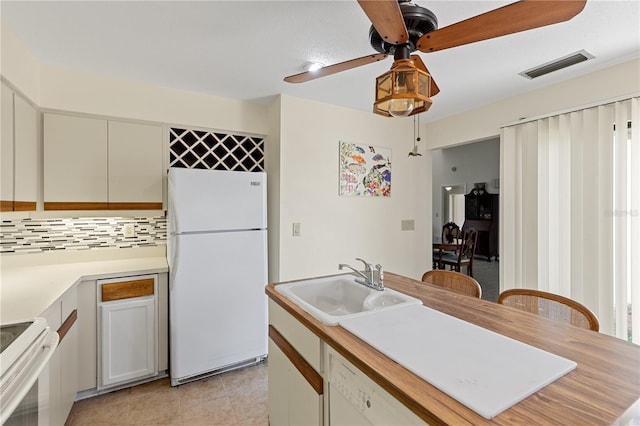 1315 Pine Needle Rd, Venice, FL 34285 - kitchen with white appliances, decorative backsplash, ceiling fan, light countertops, and light tile patterned flooring