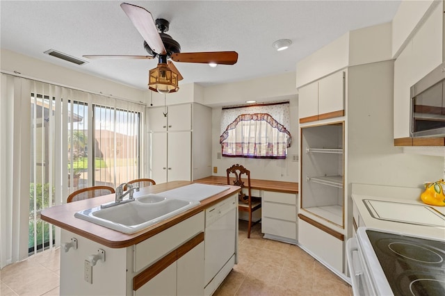 1315 Pine Needle Rd, Venice, FL 34285 - kitchen featuring white dishwasher, range, a kitchen island with sink, a ceiling fan, and light tile patterned flooring