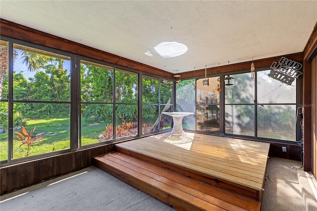 1315 Pine Needle Rd, Venice, FL 34285 - unfurnished sunroom featuring carpet flooring, plenty of natural light, and a textured ceiling