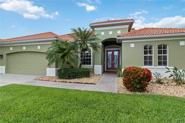 6619 Pinefeather Ct, Bradenton, FL 34203 - mediterranean / spanish-style home with french doors, a tiled roof, stucco siding, and a front yard