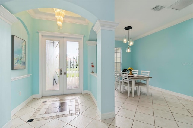 6619 Pinefeather Ct, Bradenton, FL 34203 - entrance foyer featuring light tile patterned floors, french doors, ornamental molding, and a chandelier