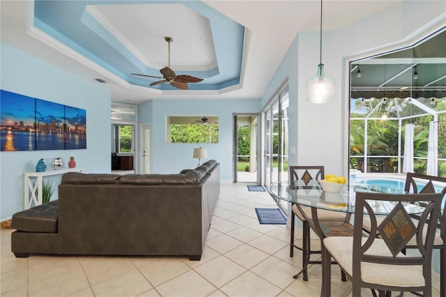 6619 Pinefeather Ct, Bradenton, FL 34203 - living area with ceiling fan, a tray ceiling, light tile patterned floors, and crown molding