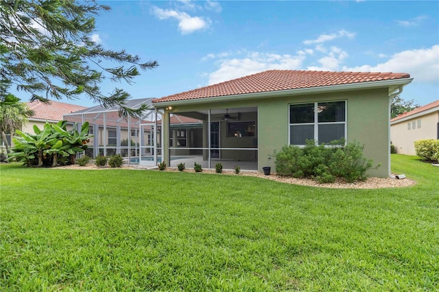 6619 Pinefeather Ct, Bradenton, FL 34203 - rear view of property with a tile roof, a yard, stucco siding, and a ceiling fan