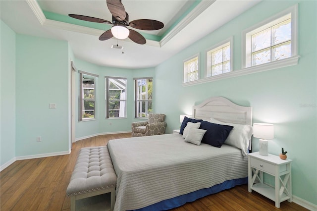 6619 Pinefeather Ct, Bradenton, FL 34203 - bedroom featuring a raised ceiling, wood finished floors, ceiling fan, and crown molding