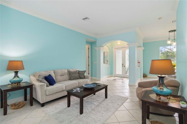 6619 Pinefeather Ct, Bradenton, FL 34203 - living area with arched walkways, light tile patterned flooring, crown molding, and decorative columns
