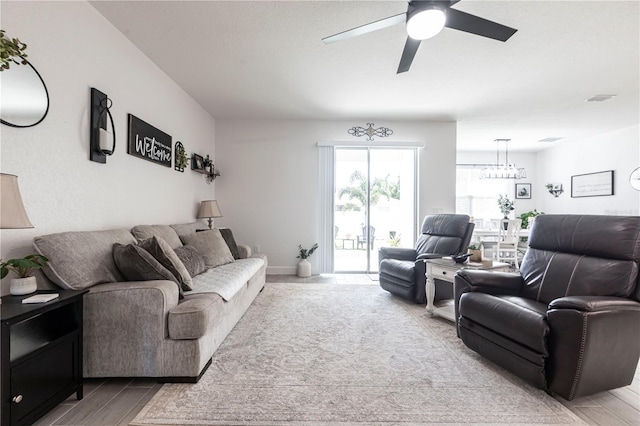 4033 Union Ln, North Port, FL 34288 - living room featuring a ceiling fan, light wood finished floors, and a chandelier