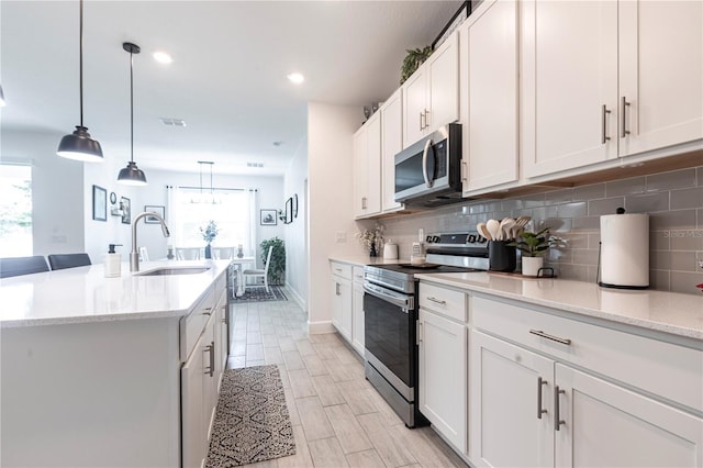 4033 Union Ln, North Port, FL 34288 - kitchen featuring appliances with stainless steel finishes, tasteful backsplash, white cabinets, pendant lighting, and recessed lighting