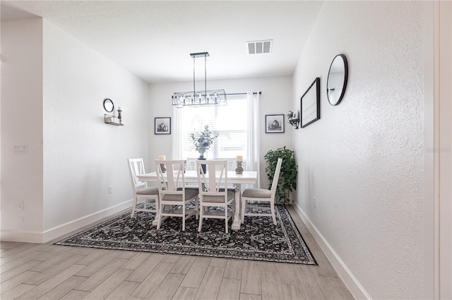 4033 Union Ln, North Port, FL 34288 - dining room featuring wood finished floors and a chandelier