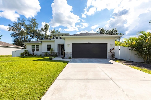 4033 Union Ln, North Port, FL 34288 - prairie-style house featuring a gate, an attached garage, stucco siding, concrete driveway, and stone siding
