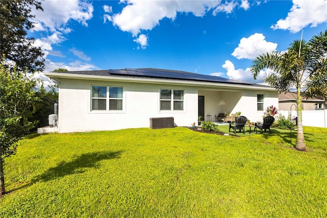 4033 Union Ln, North Port, FL 34288 - back of property featuring stucco siding, roof mounted solar panels, and a patio