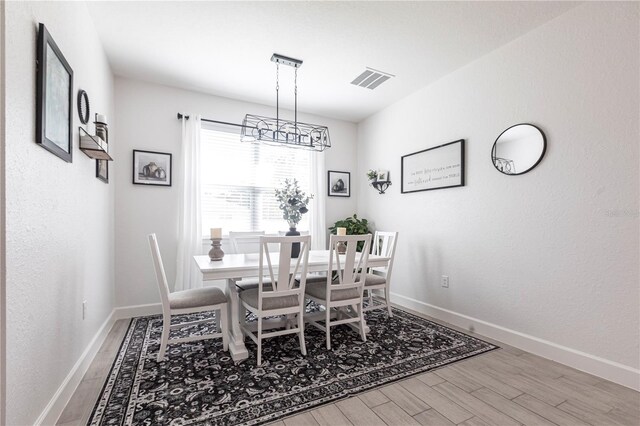 4033 Union Ln, North Port, FL 34288 - dining area with wood finished floors and a chandelier