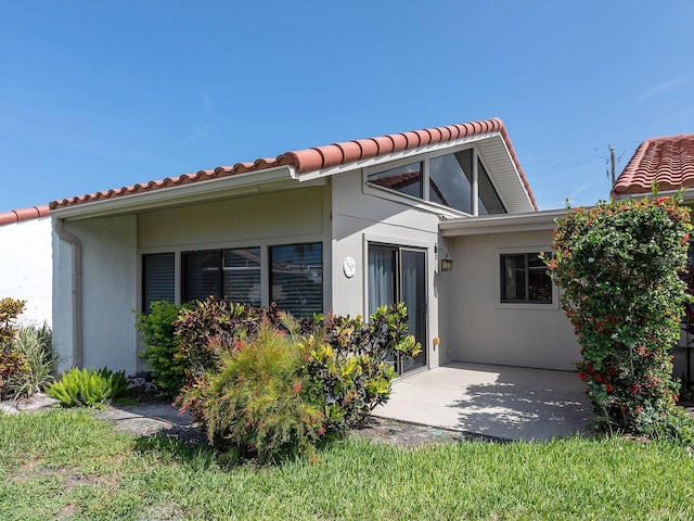 500 Park Blvd S Unit 33, Venice, FL 34285 - view of front of house with a tile roof and a patio area