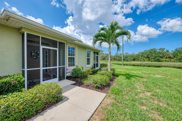 371 Capulet Dr, Venice, FL 34292 - view of green lawn featuring a sunroom and a water view