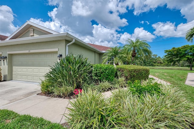 371 Capulet Dr, Venice, FL 34292 - view of side of property with stucco siding, a garage, and concrete driveway