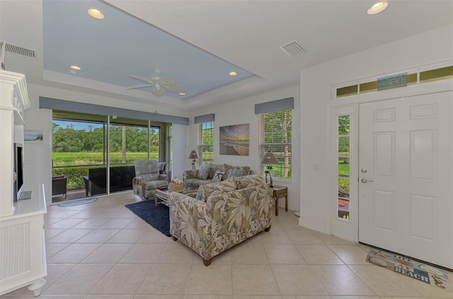 371 Capulet Dr, Venice, FL 34292 - living room with a ceiling fan, light tile patterned floors, a tray ceiling, and recessed lighting