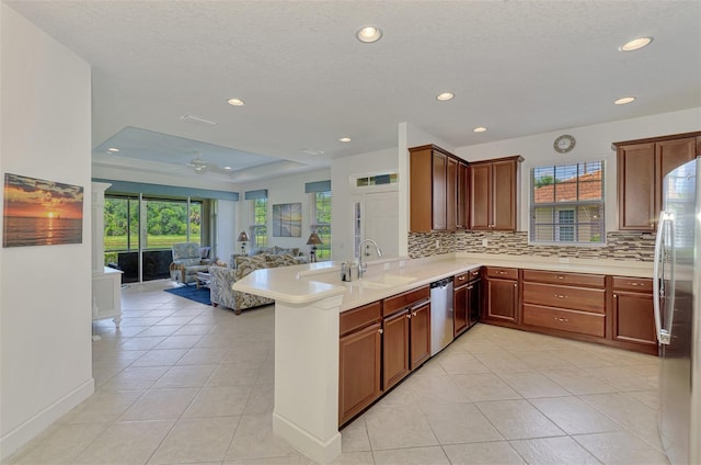 371 Capulet Dr, Venice, FL 34292 - kitchen with appliances with stainless steel finishes, open floor plan, backsplash, recessed lighting, and light tile patterned floors