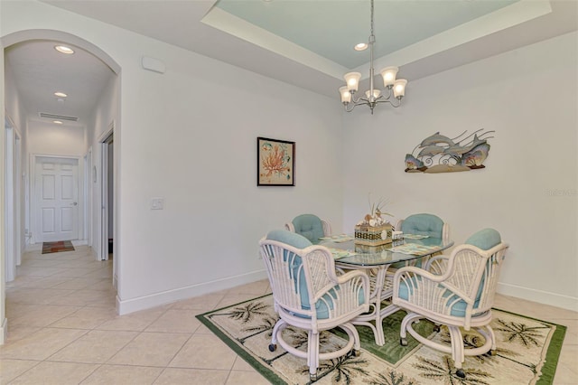 371 Capulet Dr, Venice, FL 34292 - dining space with arched walkways, light tile patterned flooring, a chandelier, recessed lighting, and a tray ceiling