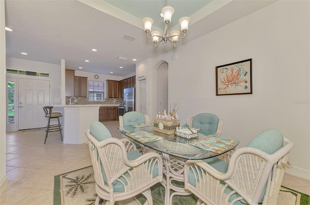371 Capulet Dr, Venice, FL 34292 - dining room with a chandelier, light tile patterned flooring, recessed lighting, and arched walkways