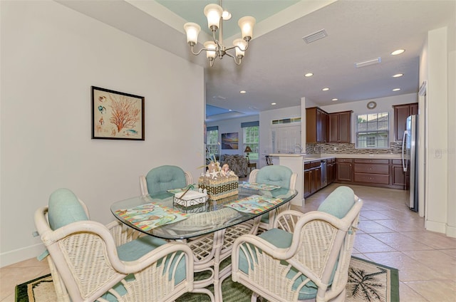 371 Capulet Dr, Venice, FL 34292 - dining area with a chandelier, recessed lighting, and light tile patterned floors
