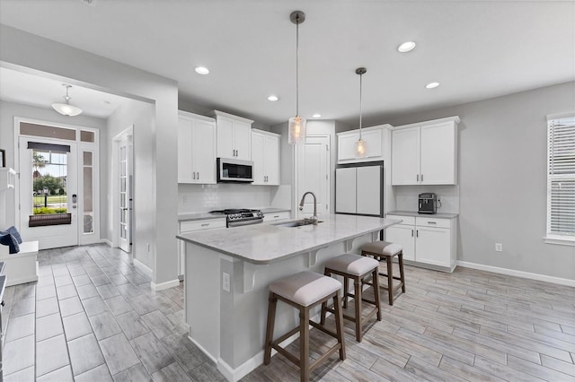 11240 Spring Gate Trl, Bradenton, FL 34211 - kitchen featuring stainless steel gas range oven, fridge, light wood-style floors, decorative backsplash, and recessed lighting