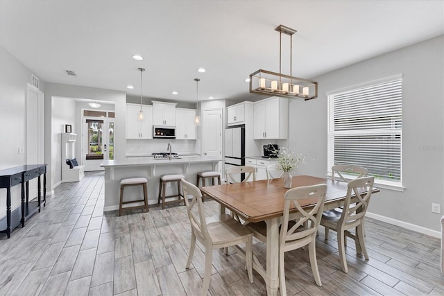 11240 Spring Gate Trl, Bradenton, FL 34211 - dining area with wood tiled floors and recessed lighting