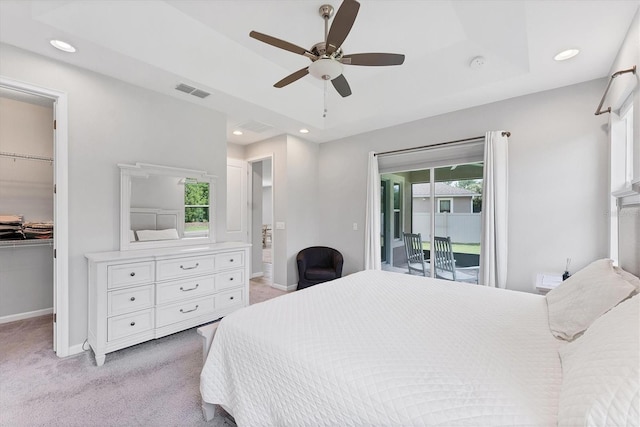 11240 Spring Gate Trl, Bradenton, FL 34211 - bedroom with a walk in closet, light colored carpet, access to outside, recessed lighting, and ensuite bath