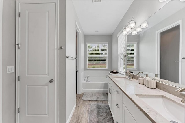 11240 Spring Gate Trl, Bradenton, FL 34211 - full bath featuring a garden tub, double vanity, and wood finished floors
