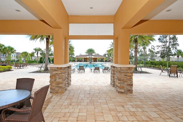 11240 Spring Gate Trl, Bradenton, FL 34211 - view of patio featuring a community pool and outdoor dining space
