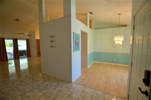 505 Duke Rd, Venice, FL 34293 - spare room featuring a chandelier, tile patterned floors, a ceiling fan, and high vaulted ceiling