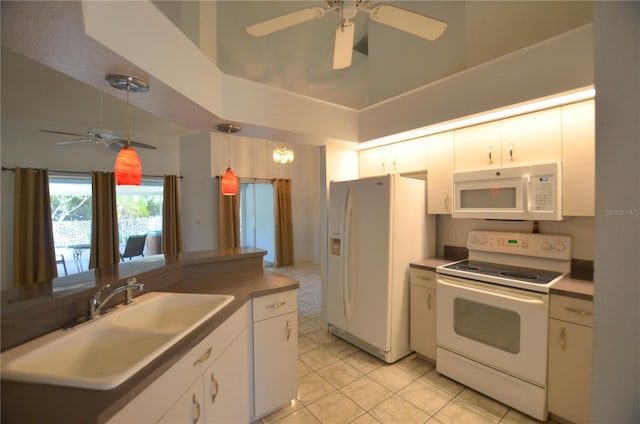 505 Duke Rd, Venice, FL 34293 - kitchen with white appliances, ceiling fan, high vaulted ceiling, white cabinets, and decorative light fixtures