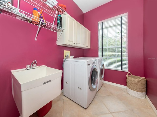 819 Shadow Bay Way, Osprey, FL 34229 - laundry area featuring cabinet space, washing machine and clothes dryer, and light tile patterned floors