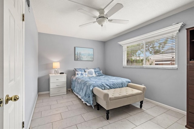 614 Guild Dr Unit 10, Venice, FL 34285 - bedroom featuring a ceiling fan, a textured ceiling, and light tile patterned floors