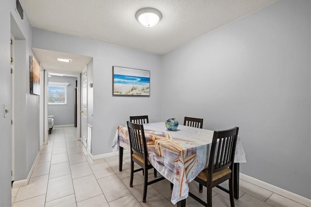 614 Guild Dr Unit 10, Venice, FL 34285 - dining area featuring a textured ceiling and light tile patterned floors