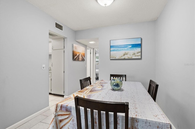 614 Guild Dr Unit 10, Venice, FL 34285 - dining space featuring a textured ceiling and light tile patterned floors