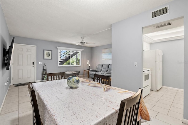 614 Guild Dr Unit 10, Venice, FL 34285 - dining area featuring light tile patterned floors, a ceiling fan, and a textured ceiling