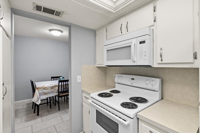 614 Guild Dr Unit 10, Venice, FL 34285 - kitchen featuring white appliances, light countertops, and white cabinetry