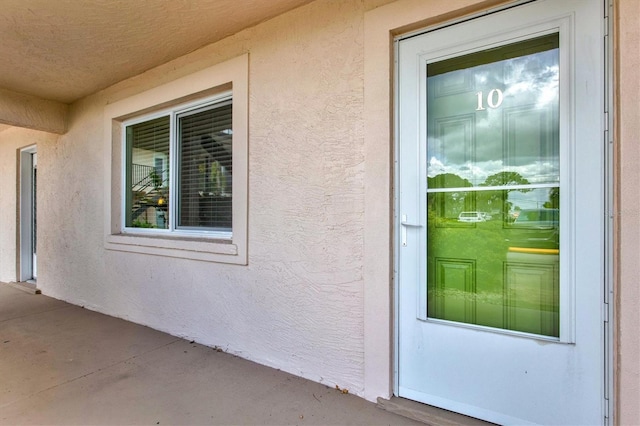 614 Guild Dr Unit 10, Venice, FL 34285 - doorway to property with stucco siding
