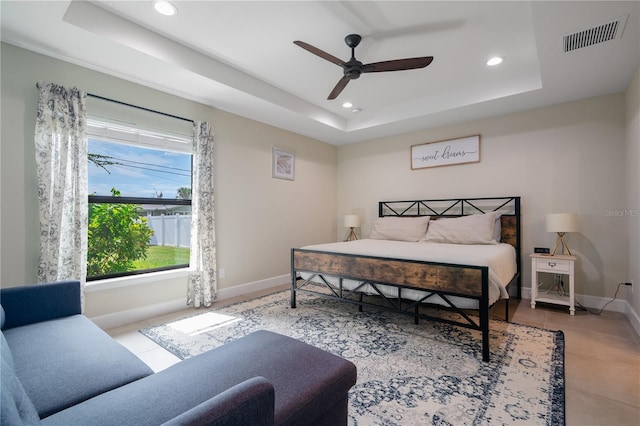 7257 Maguire Ln, Englewood, FL 34224 - tiled bedroom featuring a tray ceiling, recessed lighting, and a ceiling fan