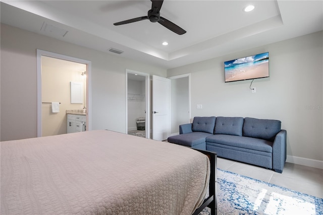 7257 Maguire Ln, Englewood, FL 34224 - bedroom with a raised ceiling, recessed lighting, connected bathroom, light tile patterned floors, and ceiling fan