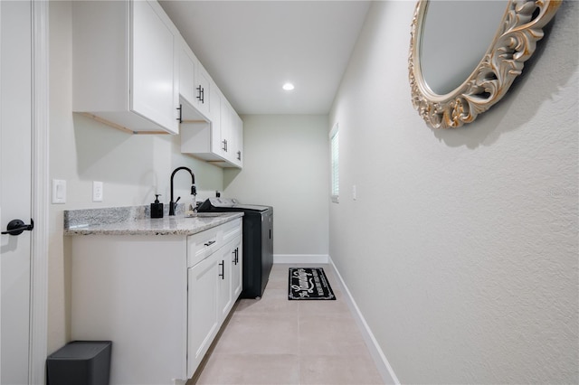7257 Maguire Ln, Englewood, FL 34224 - laundry room with cabinet space, recessed lighting, light tile patterned flooring, and separate washer and dryer
